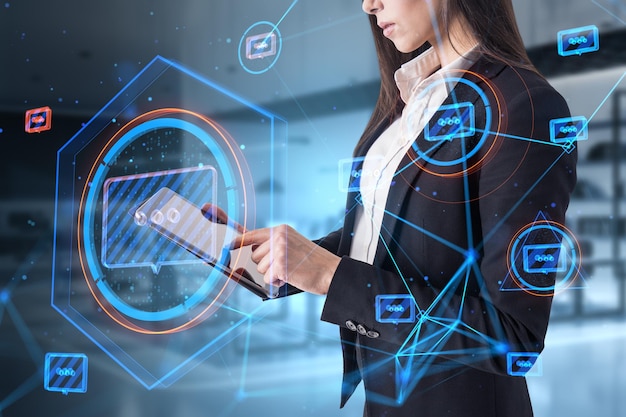 businesswoman using tablet with creative glowing connected communication hologram