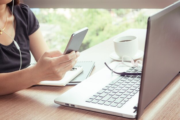 Businesswoman using technologies at table in cafe