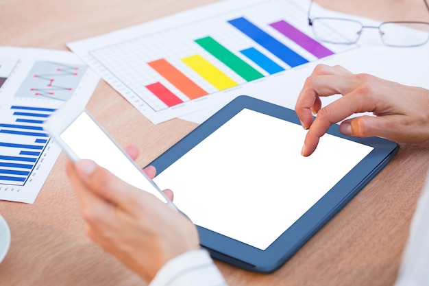 Businesswoman using two digital tablet 