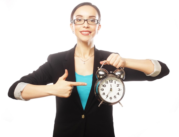 Businesswoman wearing glasses holding alarm clock