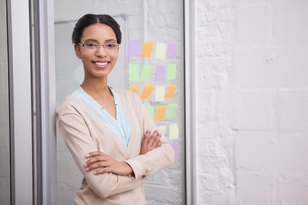 Businesswoman wearing glasses and smiling at camera