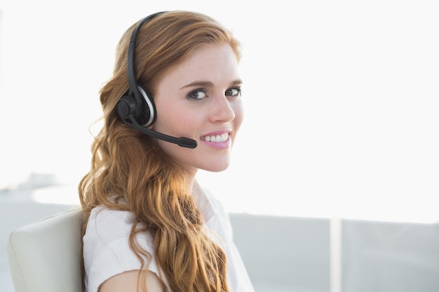 Businesswoman wearing headset in office