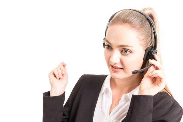 Businesswoman wearing headset standing against white background