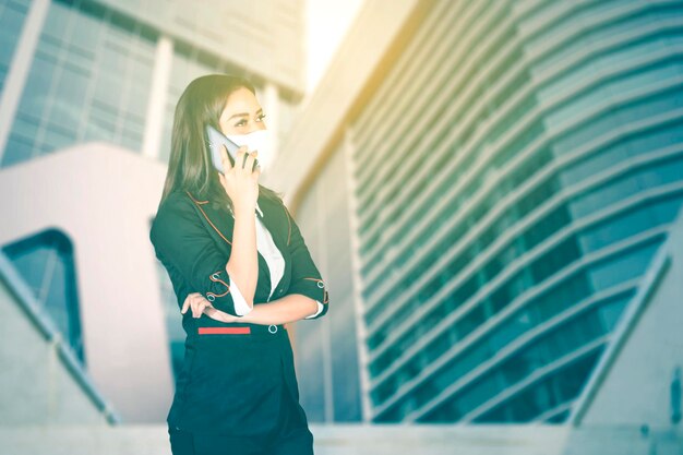 Businesswoman wears face mask and making a phone