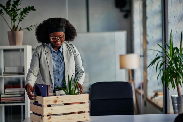 Businesswoman with belongings coming back in office