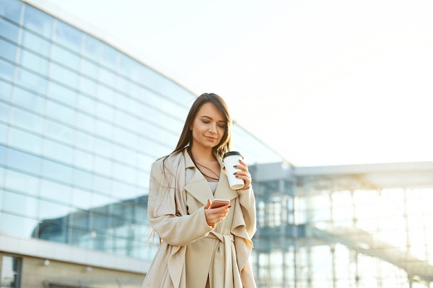 Businesswoman with a coffee and a phone