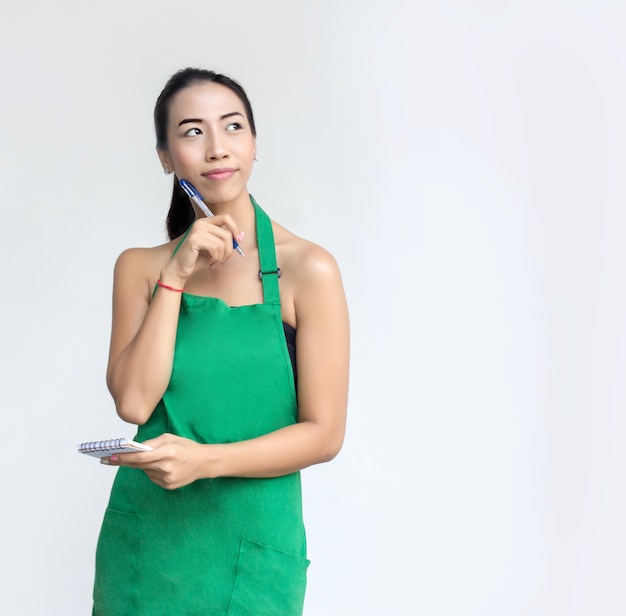 businesswoman with green apron chock to list order