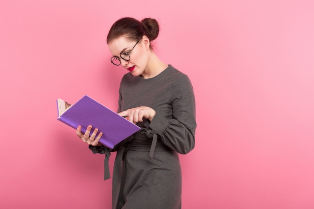 Businesswoman with hair bun and book