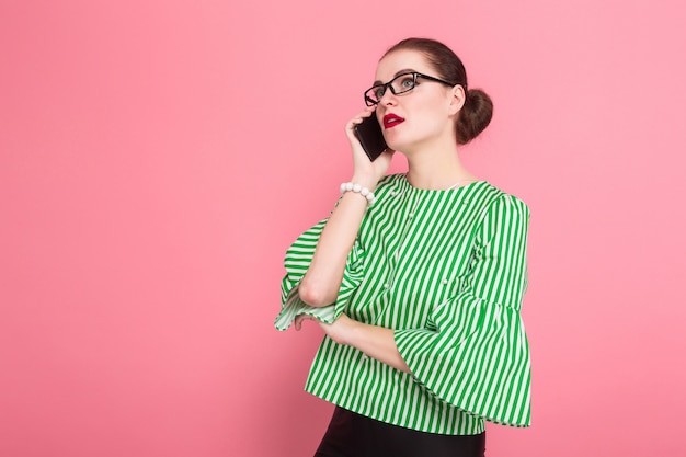 Businesswoman with hair bun and cellphone