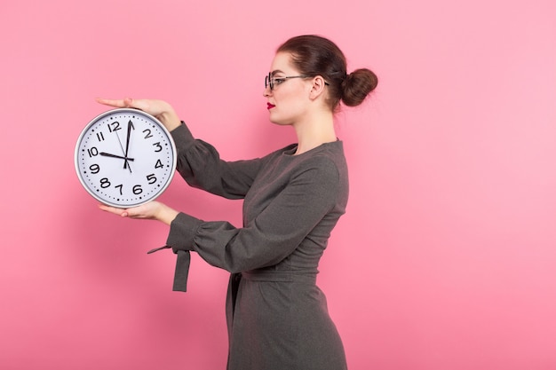 Businesswoman with hair bun and clocks