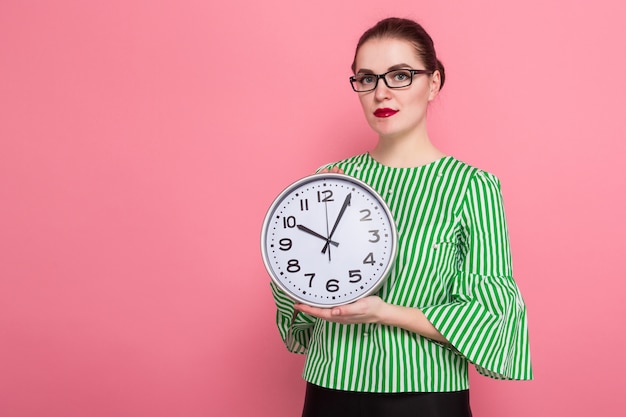 Businesswoman with hair bun and clocks