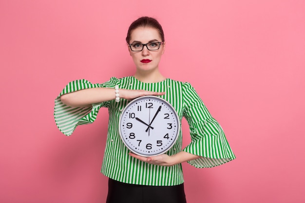 Businesswoman with hair bun and clocks