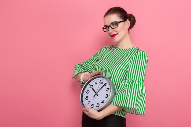 Businesswoman with hair bun and clocks