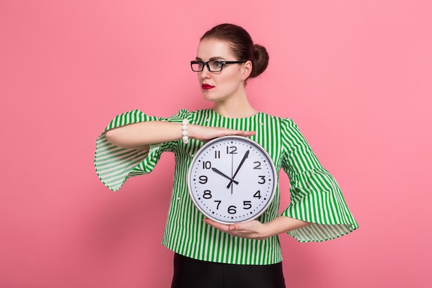 Businesswoman with hair bun and clocks