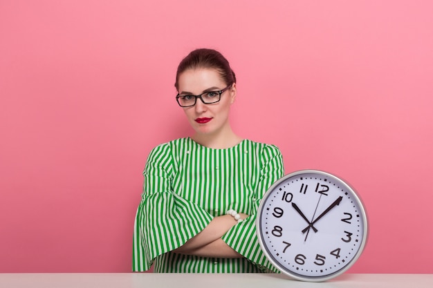 Businesswoman with hair bun and clocks