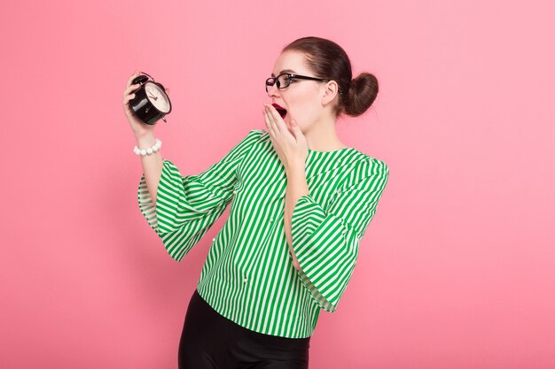 Businesswoman with hair bun and clocks