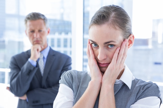 Businesswoman with hands on her face