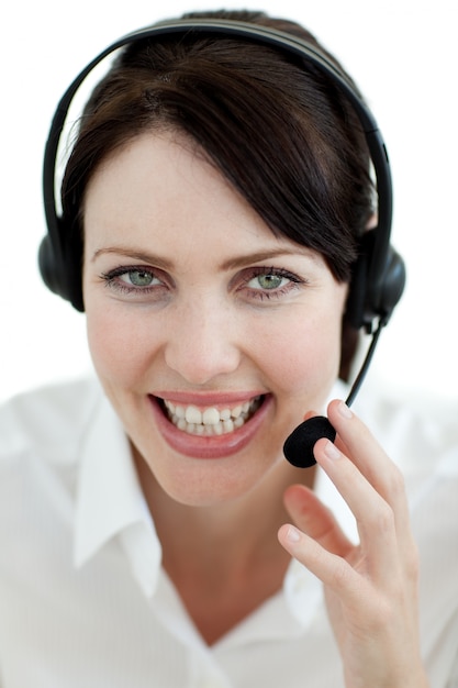 Businesswoman with headset on smiling at the camera