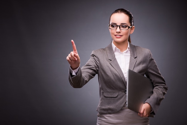 Businesswoman with laptop in business concept