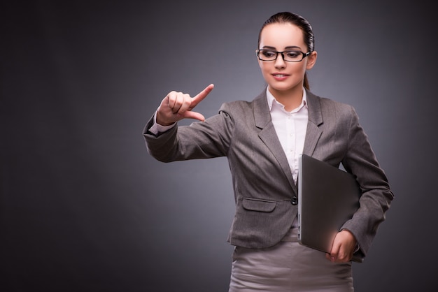 Businesswoman with laptop in business concept