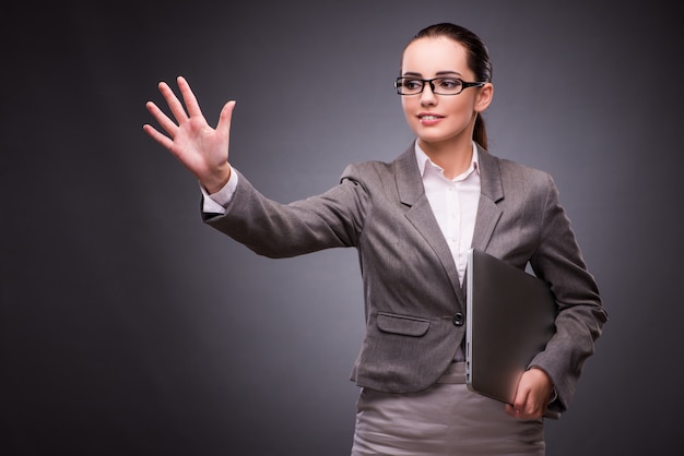 Businesswoman with laptop in business concept