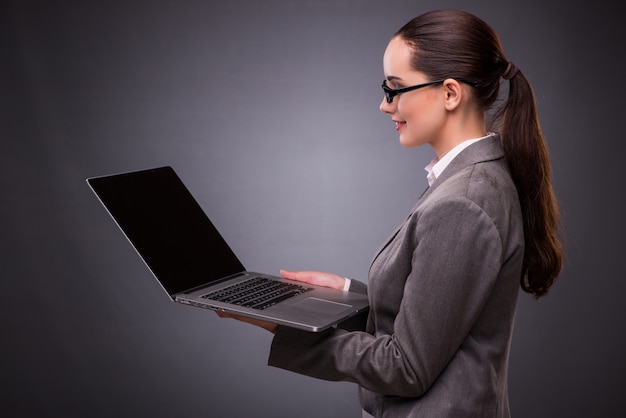 Businesswoman with laptop in business concept