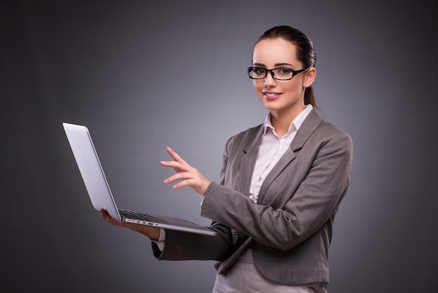 Businesswoman with laptop in business concept