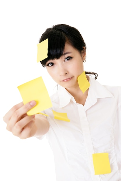 Businesswoman with many yellow memo note on her body