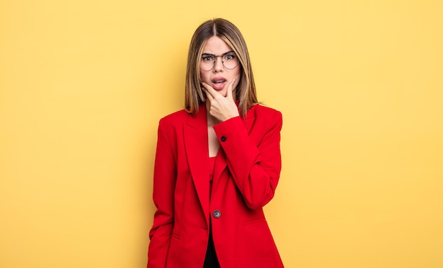 businesswoman with mouth and eyes wide open and hand on chin