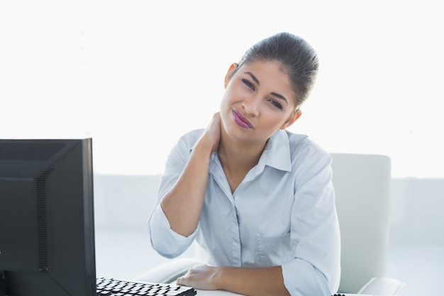 Businesswoman with neck pain in front of computer