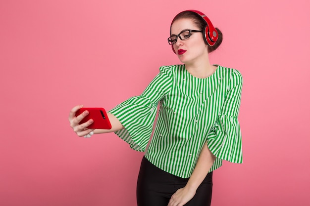 Businesswoman with phone and earphones