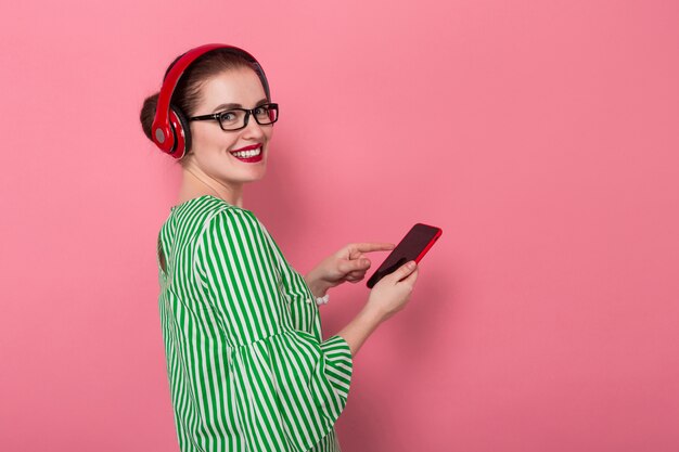 Businesswoman with phone and earphones