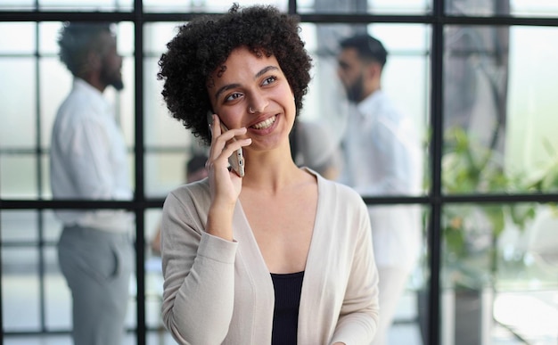 Businesswoman with phone in modern office