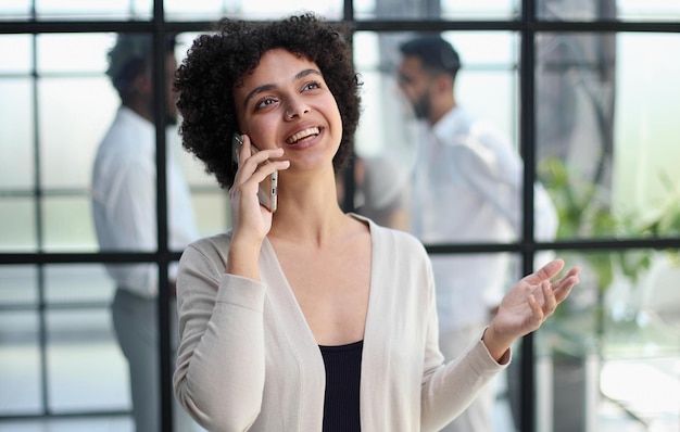 Businesswoman with phone in modern office