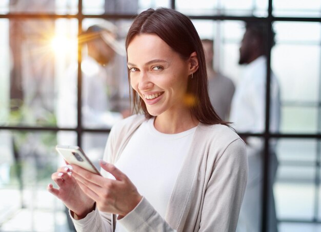 Businesswoman with phone in modern office