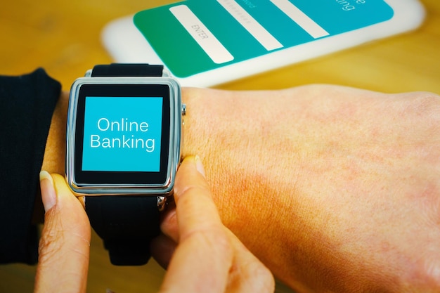 Businesswoman with smart watch on wrist against online banking