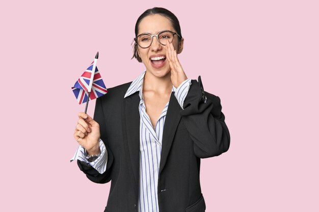 Businesswoman with UK flag symbolizing international business shouting and holding palm