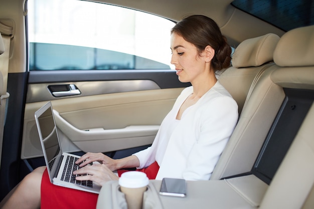 Businesswoman Working in Car