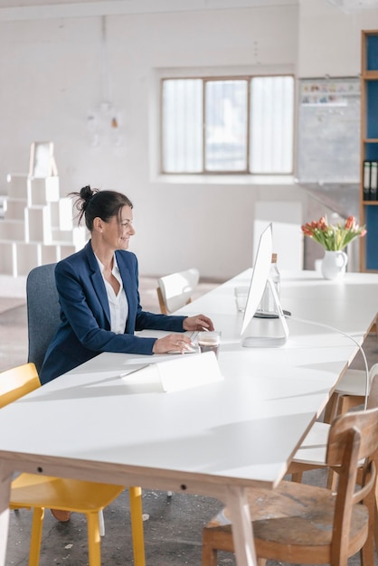 Businesswoman working at desk in a loft