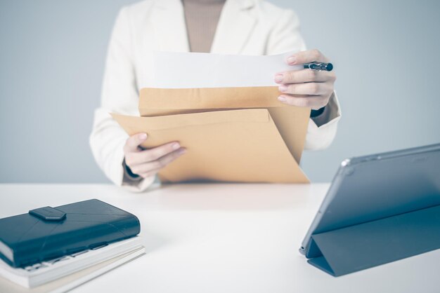 Photo businesswoman working on desk office with documentary finance and tax accounting concept