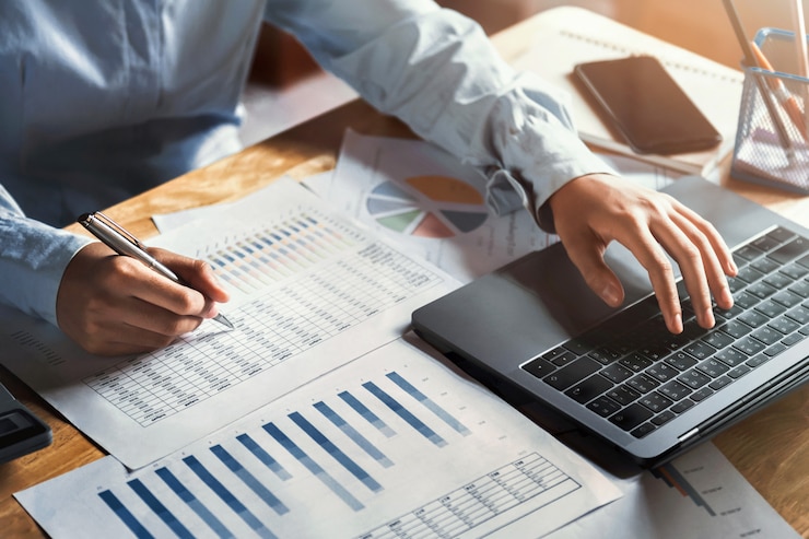 Photo businesswoman working on desk using laptop for check data of finance in office
