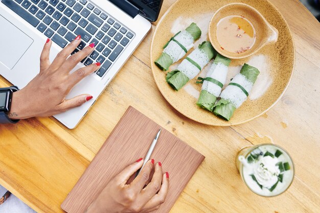 Businesswoman working during dinner