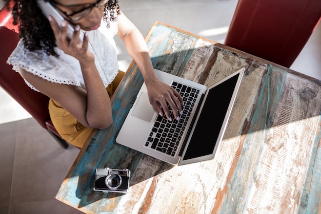 Businesswoman working from home on the mobile phone