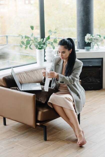 Businesswoman working from home woman paying bills image of a young pretty businesswoman working fro