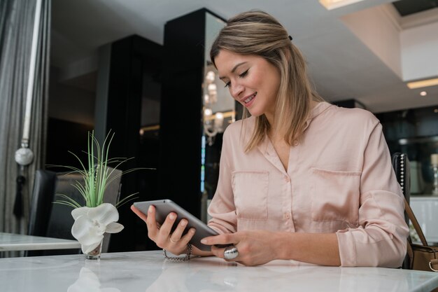 Businesswoman working on her digital tablet.