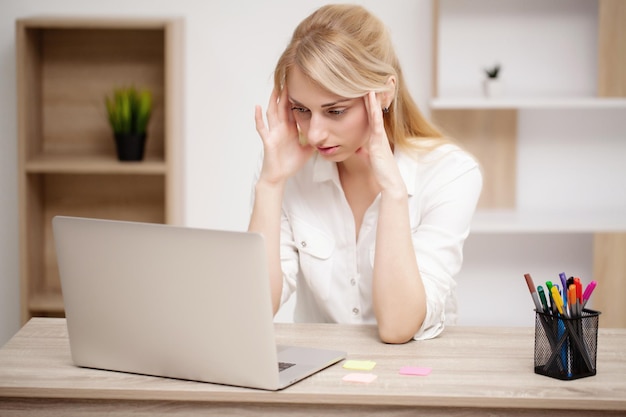 Businesswoman working on her laptop in the office.