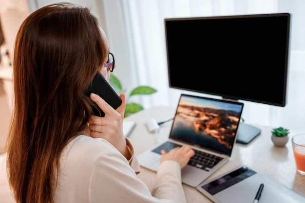 Businesswoman working at home office on laptop and talking phone with clients Young happy female student studying in online university