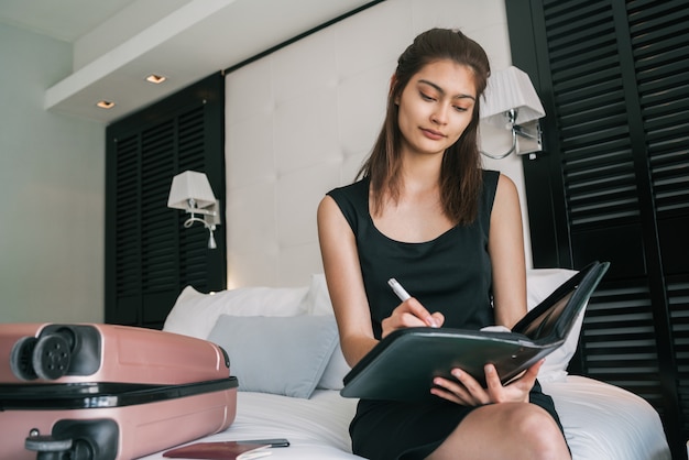 Businesswoman working at hotel room.