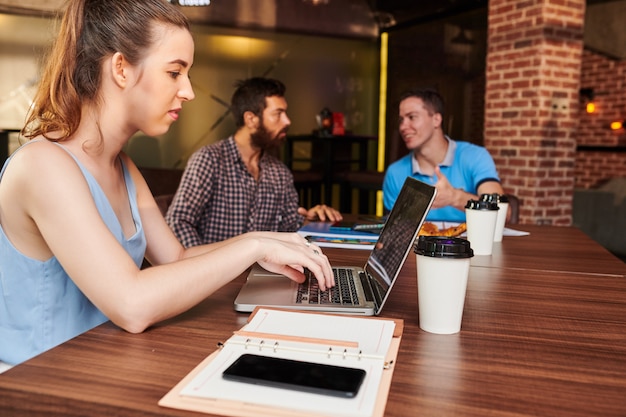 Businesswoman working on laptop in cafe