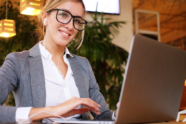 Businesswoman Working On Laptop In Coffee Shop